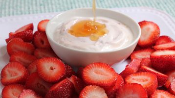strawberries with a bowl of g